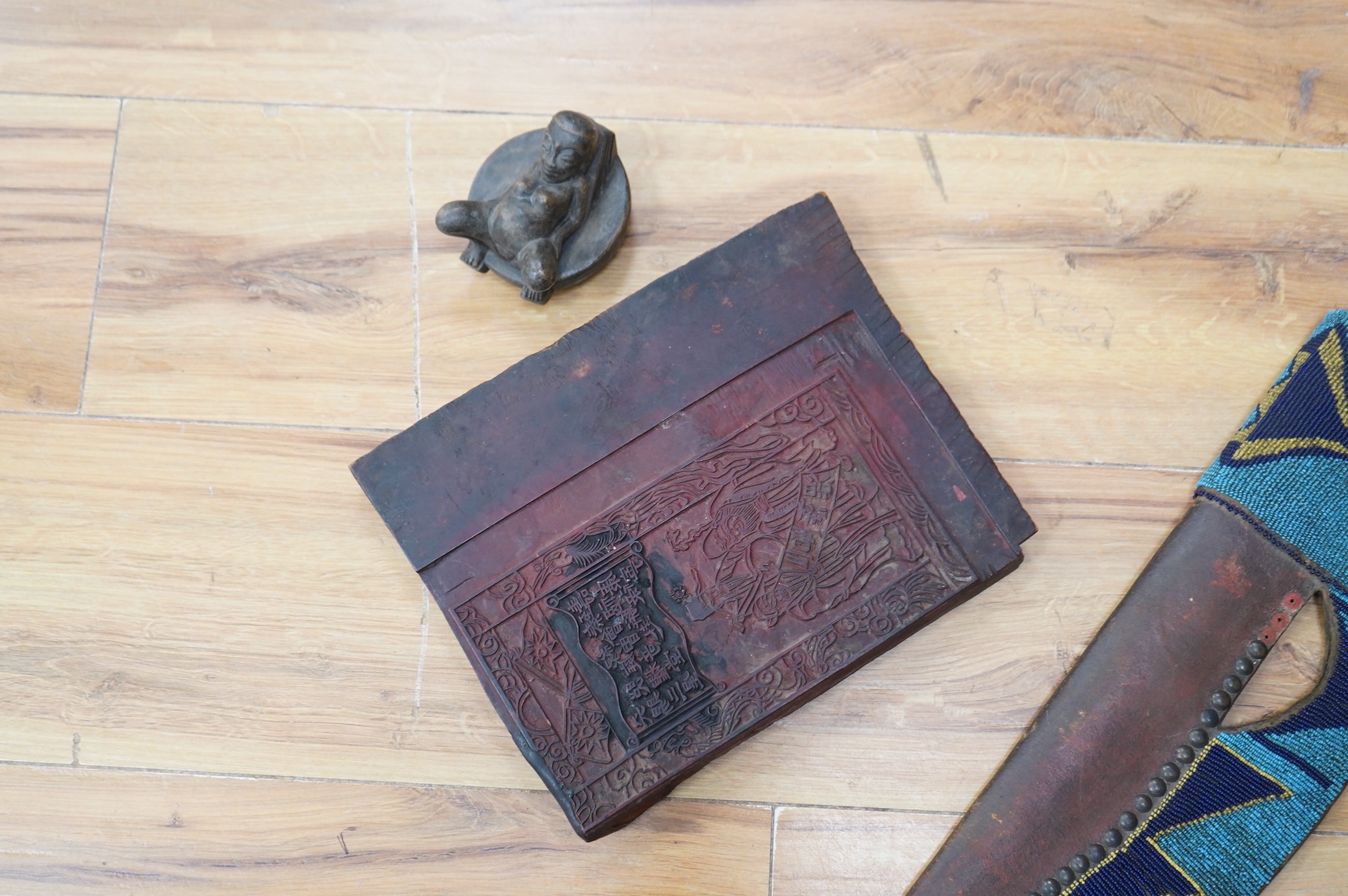 A collection of Burmese items to include wood weaving block, two figural weaving pulleys, two arrow heads and two trunk pots